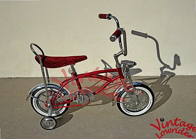 LOWRIDER COLLECTION 12" CHROME/RED BICYCLE W/72 SPOKE RIMS & LOWRIDER TIRES.